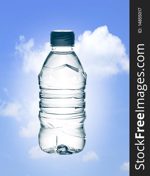 Purified spring mineral water in the bottle over blue sky