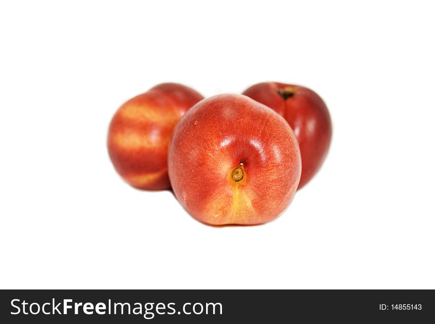 Red and juicy peaches are isolated on a white background