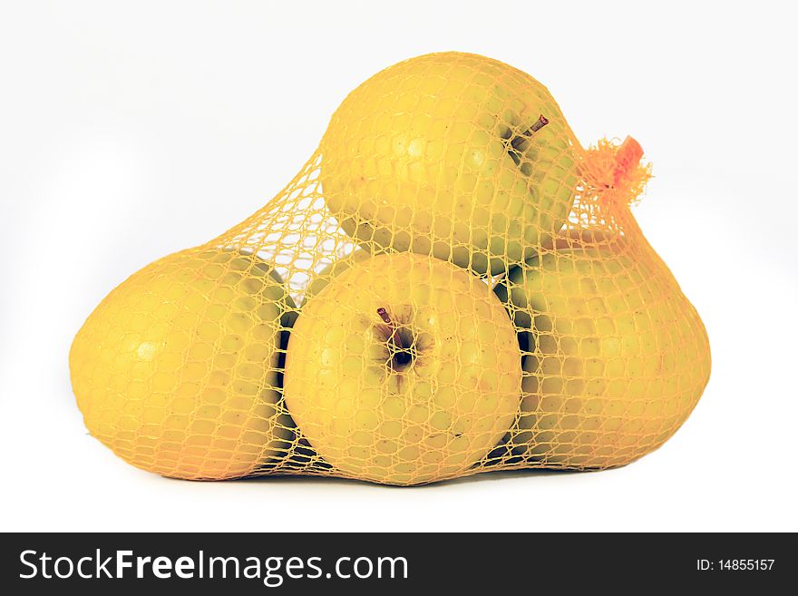 Yellow apples in network on white background