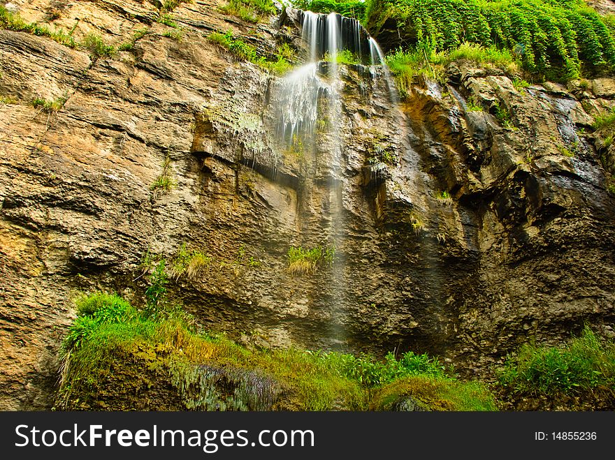 Beautiful summer waterfall at rocky mountain