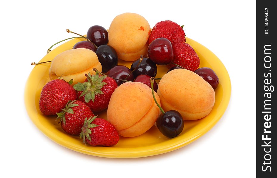 Fruits on the yellow plate. Isolated object on a white background