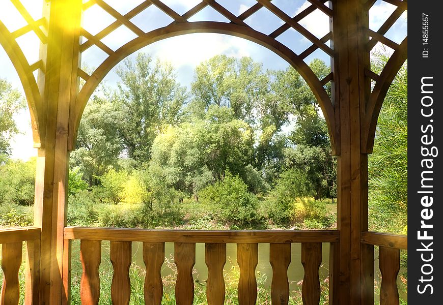 Arbour from a board on the bank of the river with a view of the wood. Arbour from a board on the bank of the river with a view of the wood