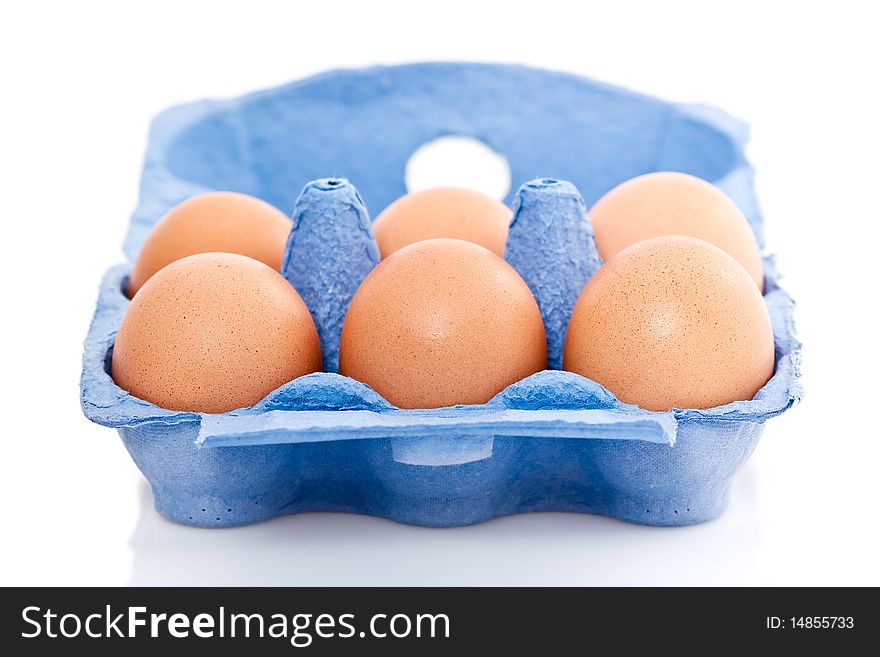 Blue box or carton of half a dozen fresh eggs isolated on white background. Blue box or carton of half a dozen fresh eggs isolated on white background