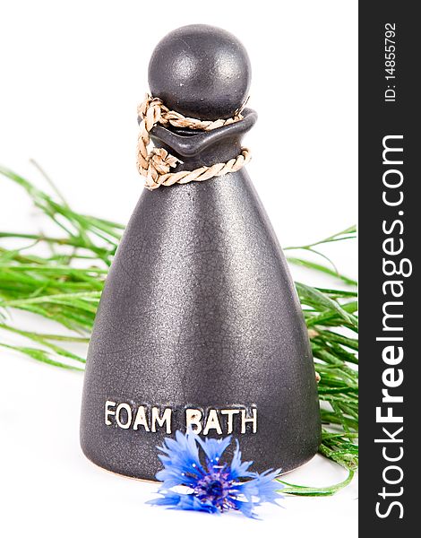 Bottle with shower gel with cornflowers over white