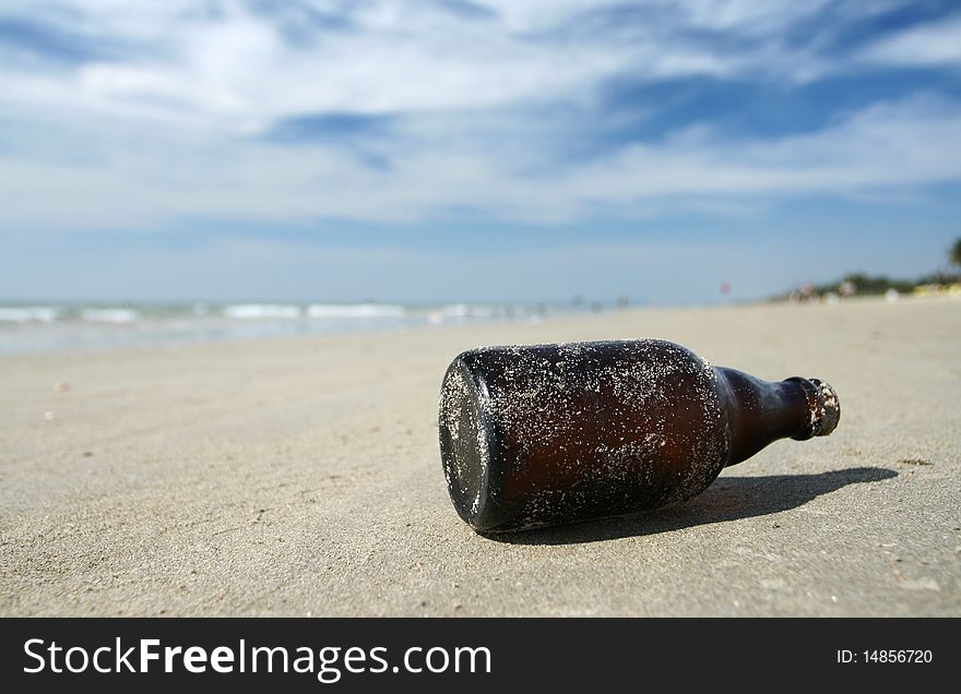 Brown bottle lying on the sea  beach. Brown bottle lying on the sea  beach