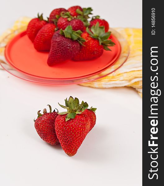 Plate of strawberries with three on white. Plate of strawberries with three on white