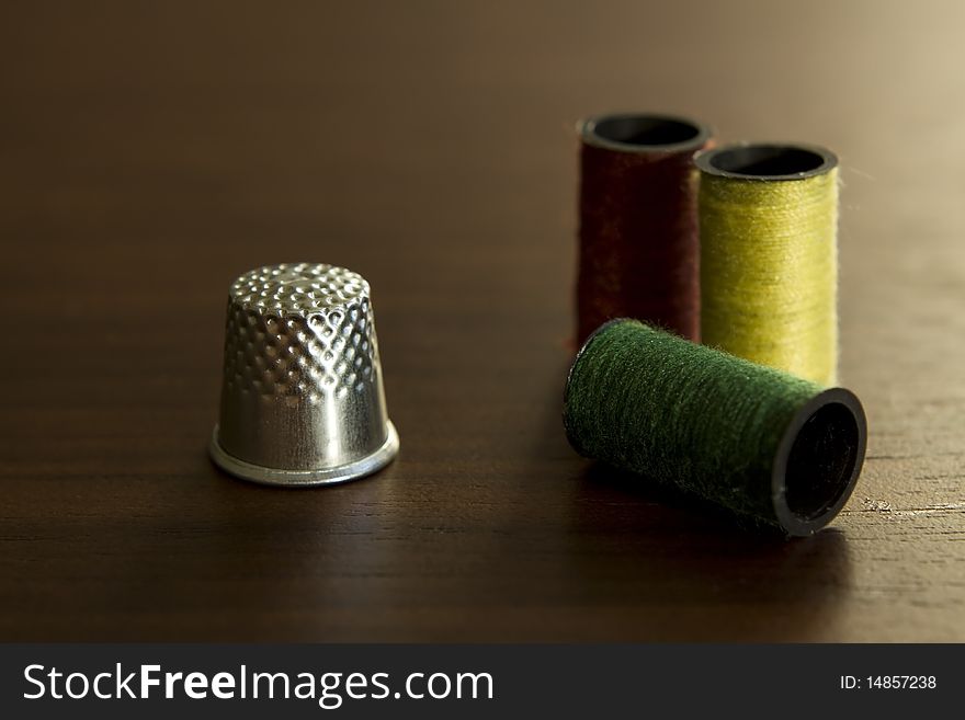 Close up of thimble and threads