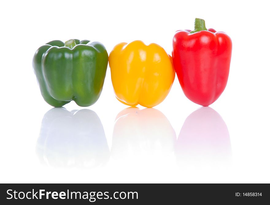 Photograph showing yellow,green and red peppers isolated