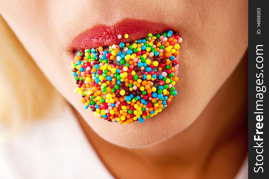 Many color bright candies on female tongue. Many color bright candies on female tongue
