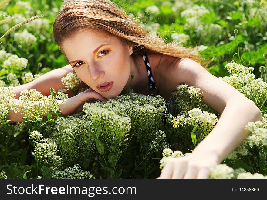 Young beautiful woman with bright makeup and white flowers. Young beautiful woman with bright makeup and white flowers