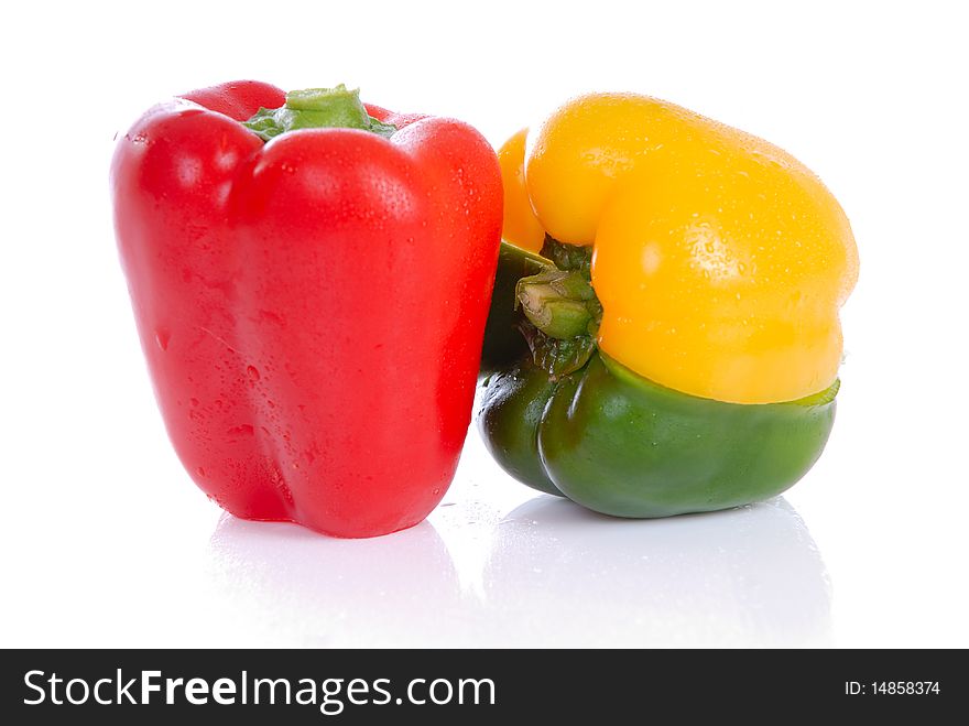 Photograph showing yellow,green and red peppers isolated