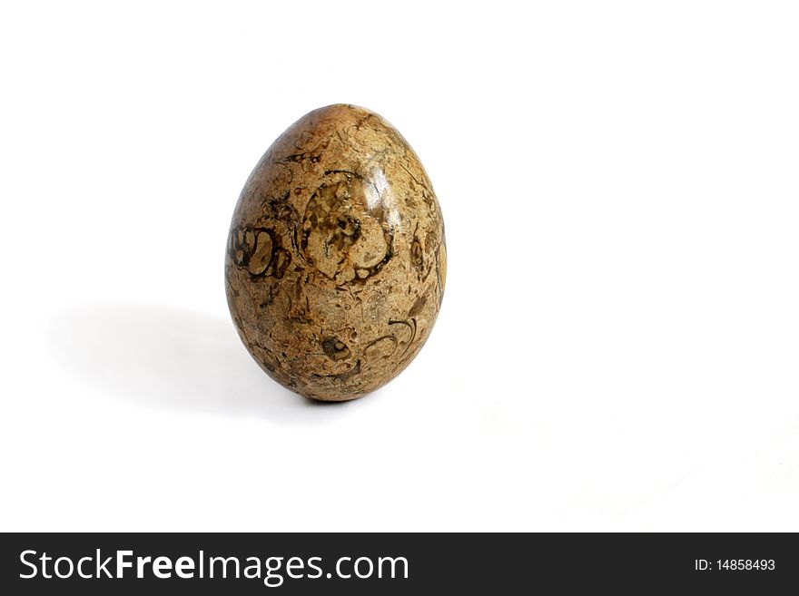 Close-up of a stone egg isolated on white background. Close-up of a stone egg isolated on white background.