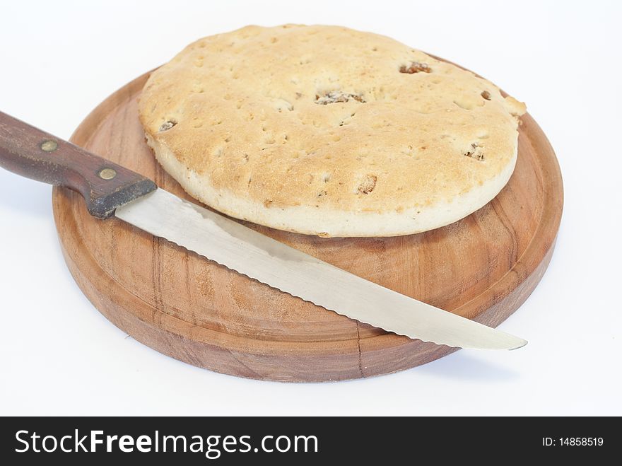 Wooden plate with bread and knife pigskin. Wooden plate with bread and knife pigskin