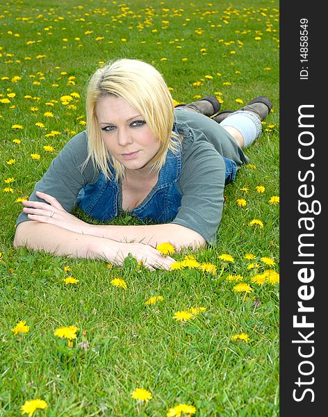 Photograph showing pretty blond girl lay in feild. Photograph showing pretty blond girl lay in feild