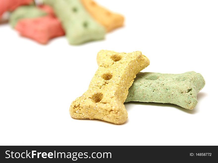 Different coloured dog treats in the shape of a bone.