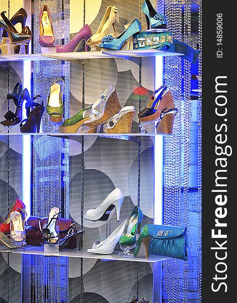 Multiple shoes in a shop in ultraviolet light. Multiple shoes in a shop in ultraviolet light