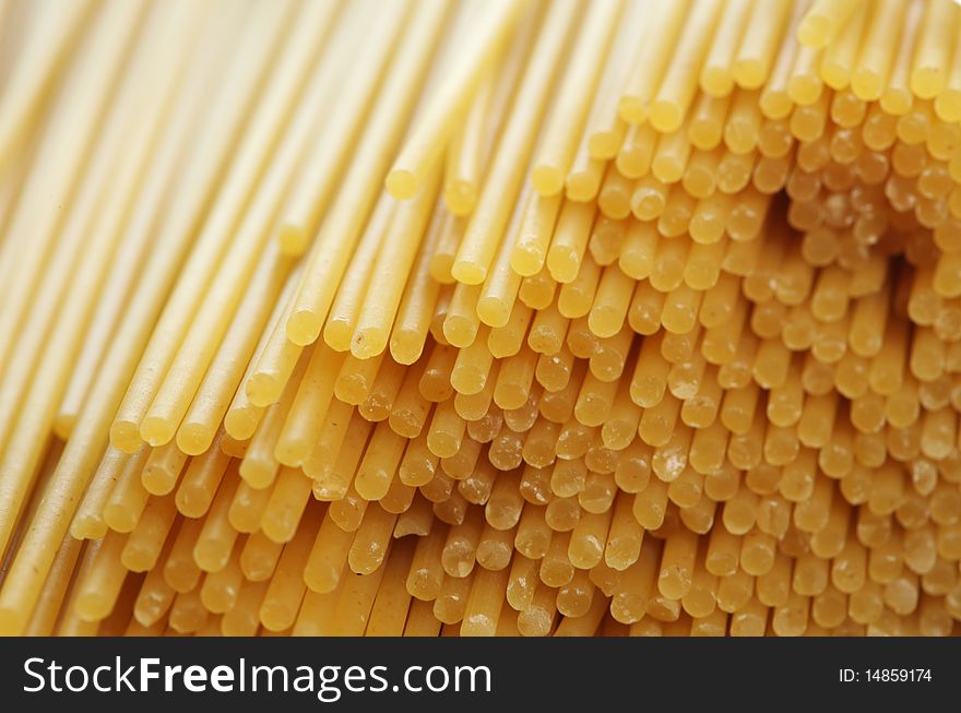Stack of raw spaghetti noddles closeup