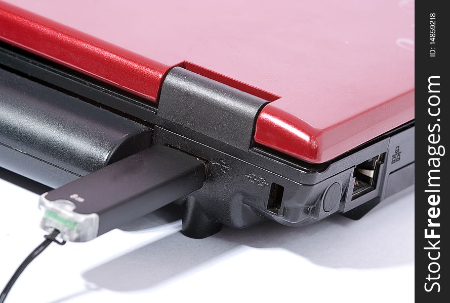 Red laptop with USB data device inserted. Red laptop with USB data device inserted