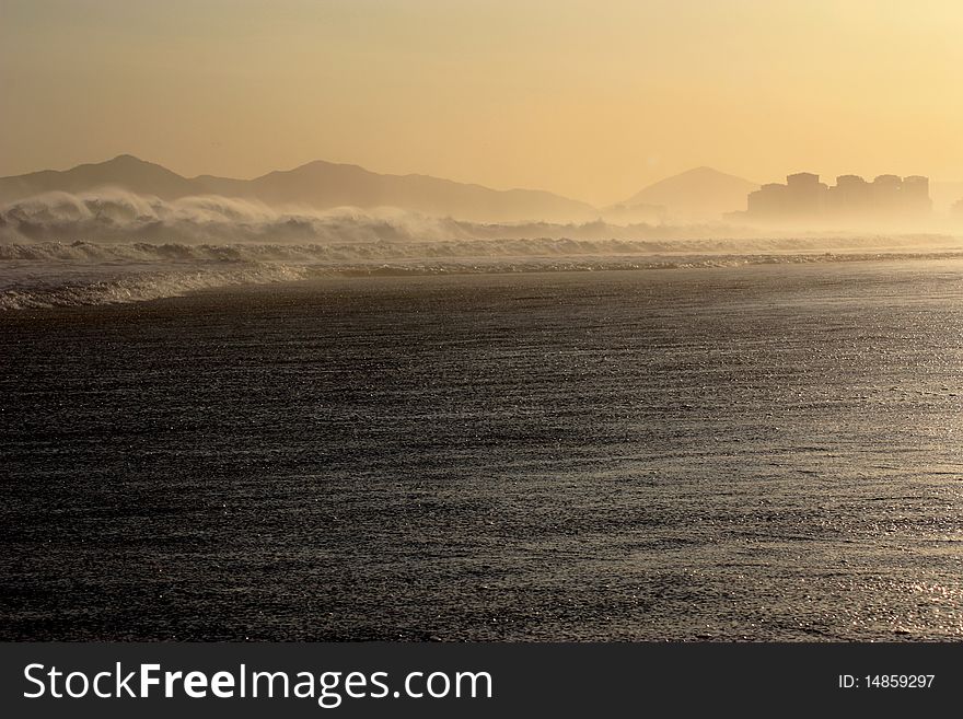 Large waves on hazy urban beach. Large waves on hazy urban beach