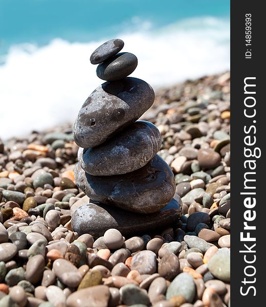 Pile of pebble stones over blue sea