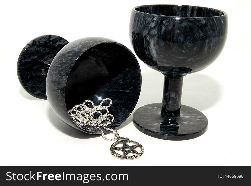 Two black marble goblets with a pentagram pendant. Two black marble goblets with a pentagram pendant