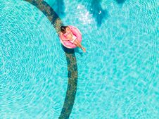 Girl In The Inflatable Circle In The Pool With A Laptop, The Concept Of Freelancing And Recreation. Royalty Free Stock Photography