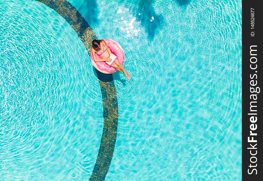 Girl In The Inflatable Circle In The Pool With A Laptop, The Concept Of Freelancing And Recreation.