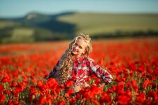 Young Blonde In A Red Shirt In The Poppy Flower Field. Royalty Free Stock Image