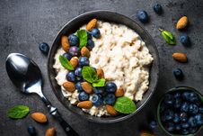 Oatmeal Porridge With Fresh Berries And Nuts Top View. Royalty Free Stock Image