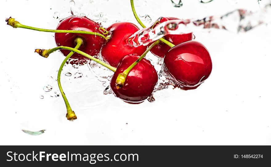 Ripe red cherry abandoned and falling into the water.