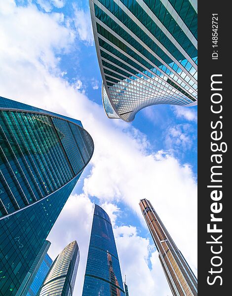 Modern multistory building on a day with blue sky, in Moscow, bottom view, perspective in architecture, business center, Moscow international business center. Modern multistory building on a day with blue sky, in Moscow, bottom view, perspective in architecture, business center, Moscow international business center