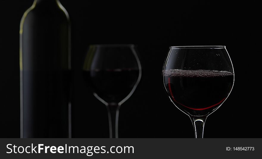 Rose Wine. Red Wine In Wine Glass Over Black Background. Silhouette