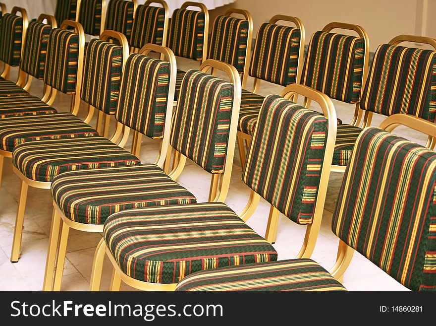 Golden chairs in coference room.