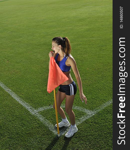 Young woman on the corner of soccer corner field with flag. Young woman on the corner of soccer corner field with flag