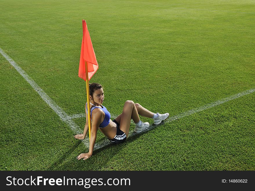 Young woman on the corner of soccer corner field with flag. Young woman on the corner of soccer corner field with flag