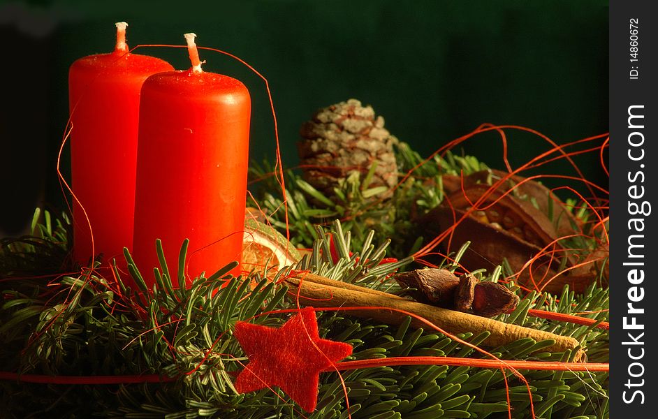 Two red candles and advent wreath with stars and cinnamon. Two red candles and advent wreath with stars and cinnamon