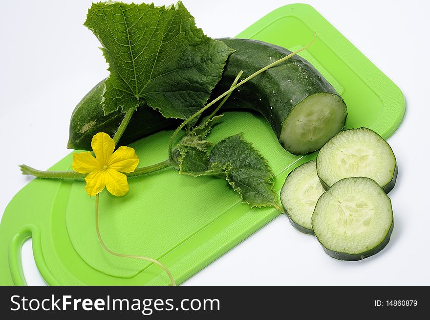 Green cucumber with flower and leaf on the white background