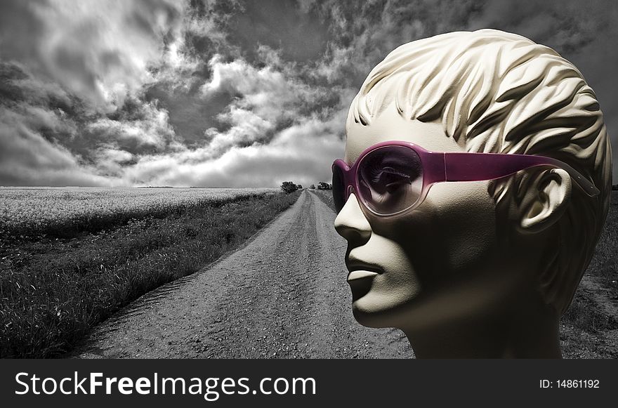 Long gravel road and mannequin with pink  sunglasses. Long gravel road and mannequin with pink  sunglasses.