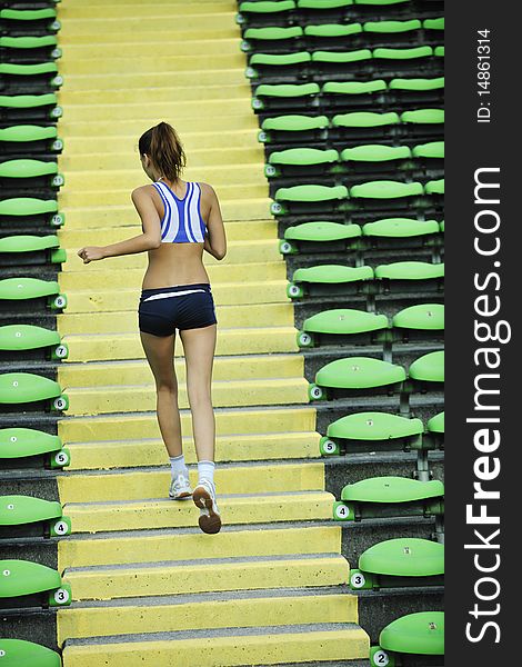 Woman Jogging At Athletics Stadium