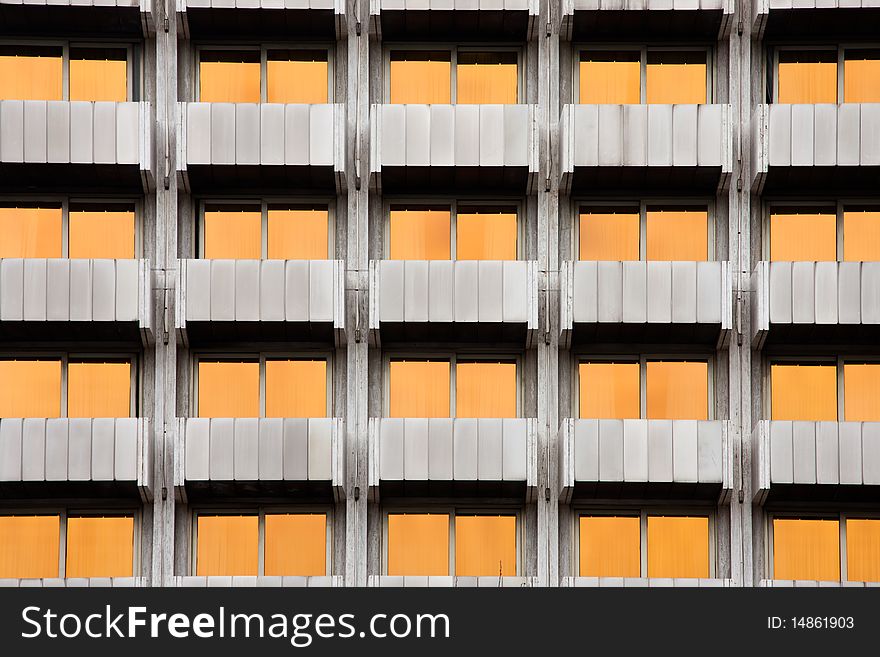 Symetrycal features of a building with yellow windows. Symetrycal features of a building with yellow windows
