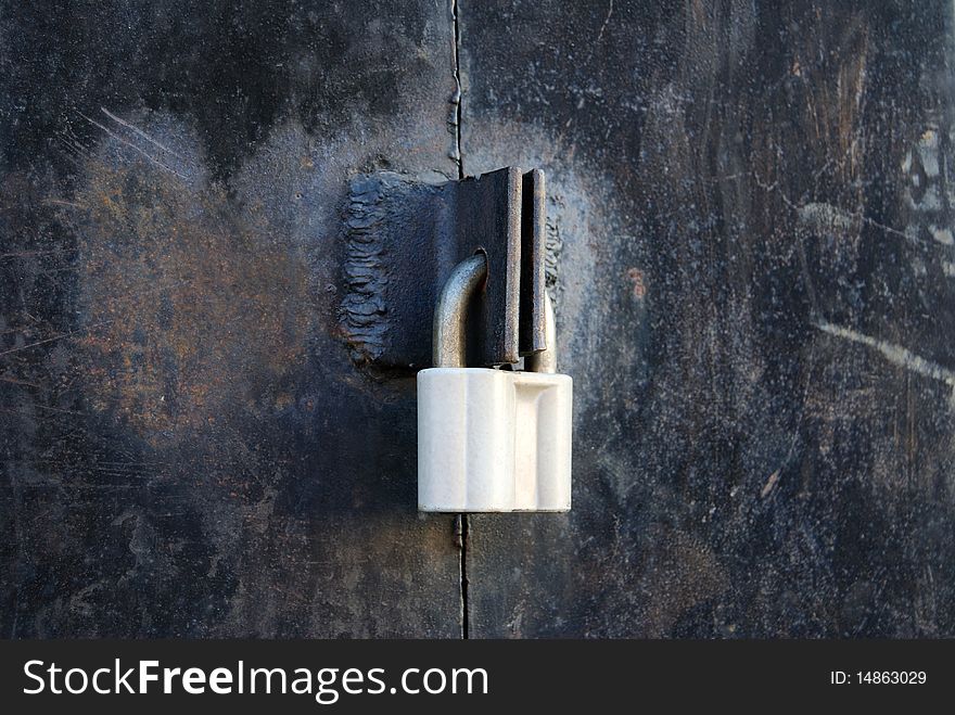 The iron door is closed on a padlock