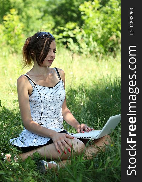 Girl with a notebook sit on the glade. Girl with a notebook sit on the glade