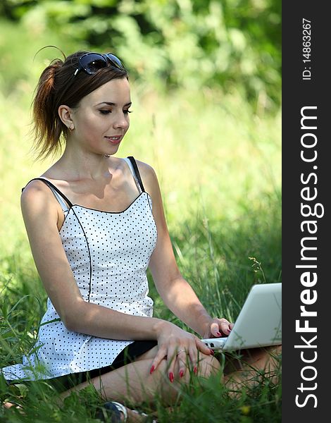 Girl with a notebook sit on the glade. Girl with a notebook sit on the glade