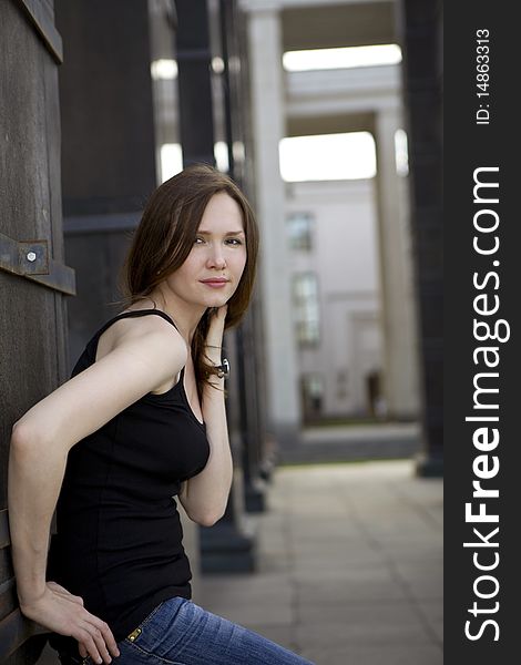 Young woman stand near column in city