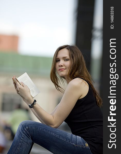 Woman with book and look at you in city. Woman with book and look at you in city
