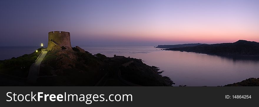 Panoramic view at dawn of coastline whit old ruins of spanish tower in Saint Teresa of Gallura Sardinia Italy copy space. Panoramic view at dawn of coastline whit old ruins of spanish tower in Saint Teresa of Gallura Sardinia Italy copy space