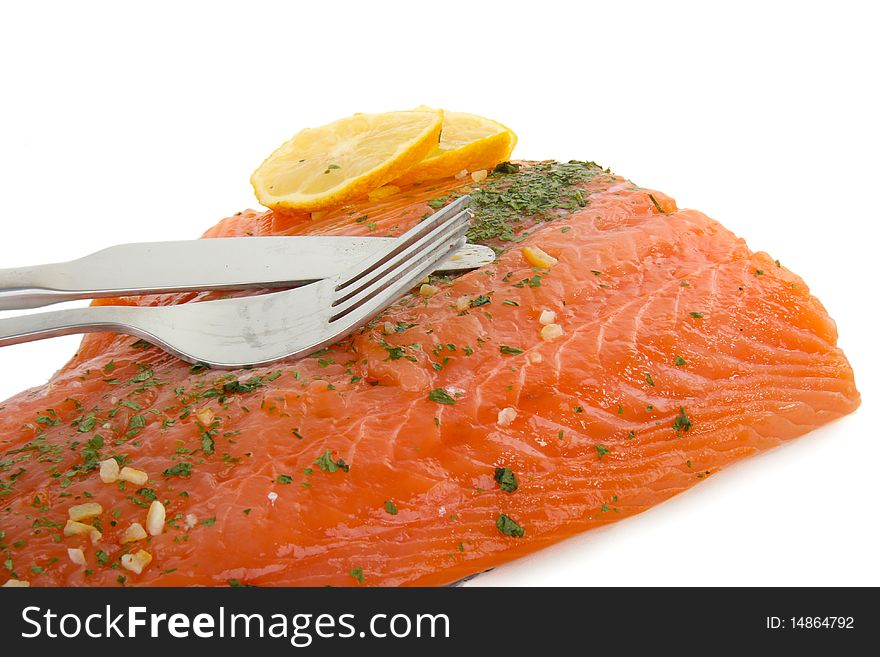 Seafood, salmon with lemon and cutlery on white background