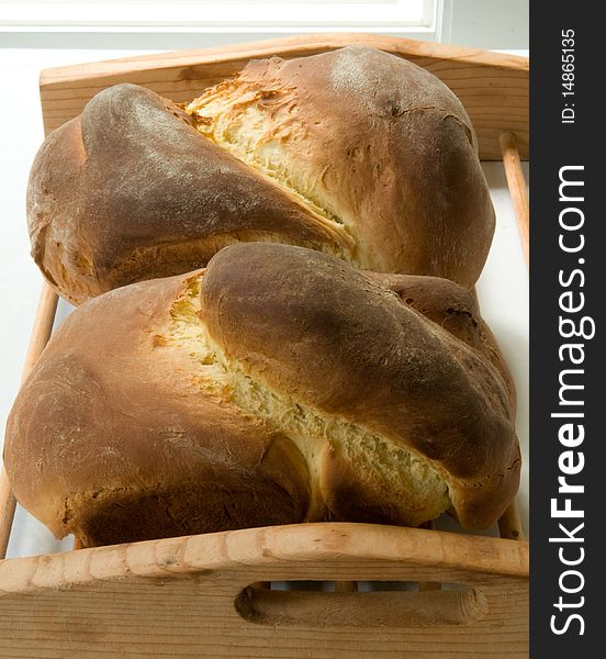 Two loaves of fresh baked Portuguese sweetbread, made with saffron, cooling on a rack. Two loaves of fresh baked Portuguese sweetbread, made with saffron, cooling on a rack