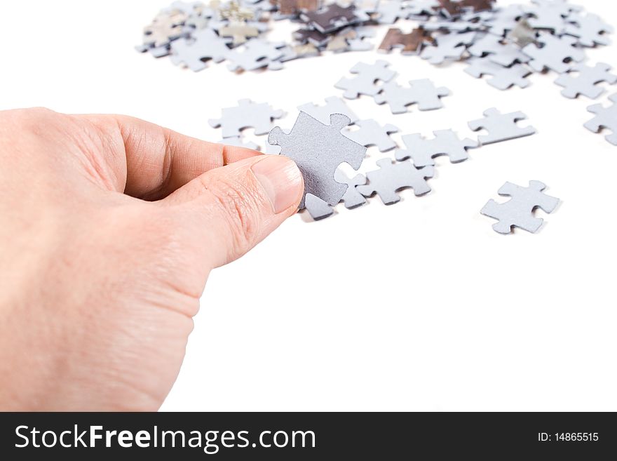 Hands holding a puzzle piece