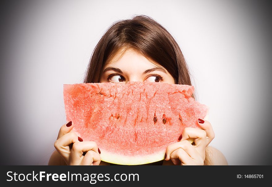 Girl with a segment of a ripe water-melon.